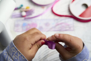 make diy bow hair clip - step 7 - hot glue ribbon to hair clip